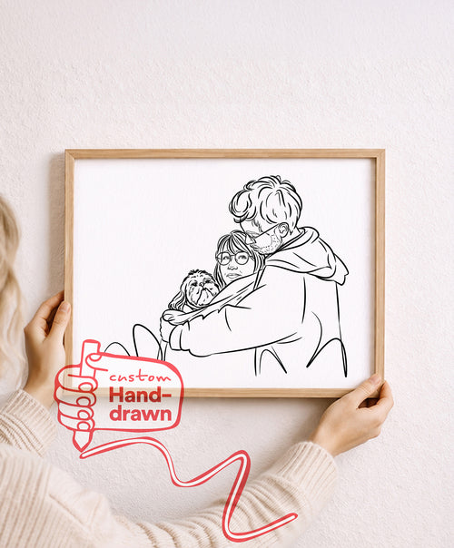 Just Line hand-drawn couple portrait with their dog, framed oak print held against a pale wall